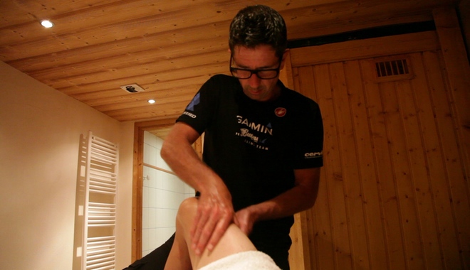 A masseuse massaging quads