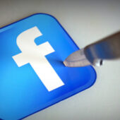 Facebook logo stabbed by a knife