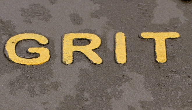 The word Grit on a concrete path