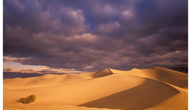 Dark clouds over sand dunes